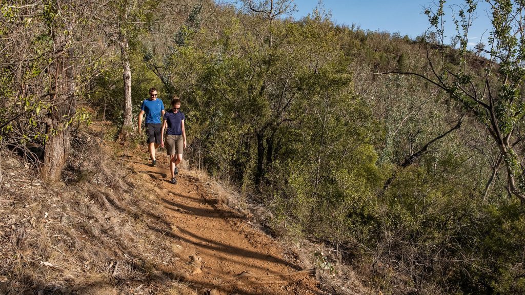Two people walking on dirt Kamilaroi walking track Tamworth