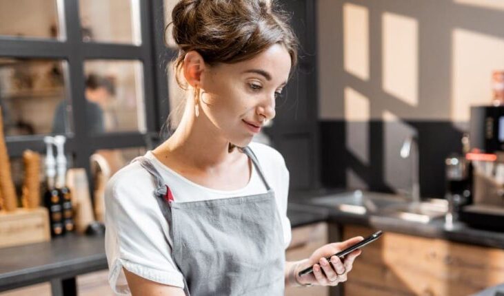 woman-cafe-apron-phone